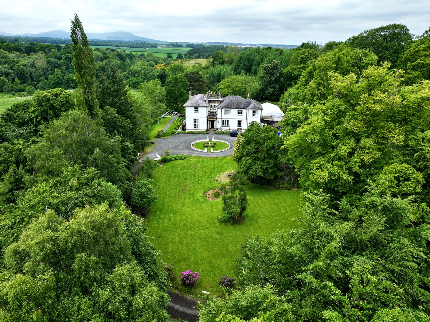 Aerial view of Kirkhill Mansion set among mature green grounds near Edinburgh